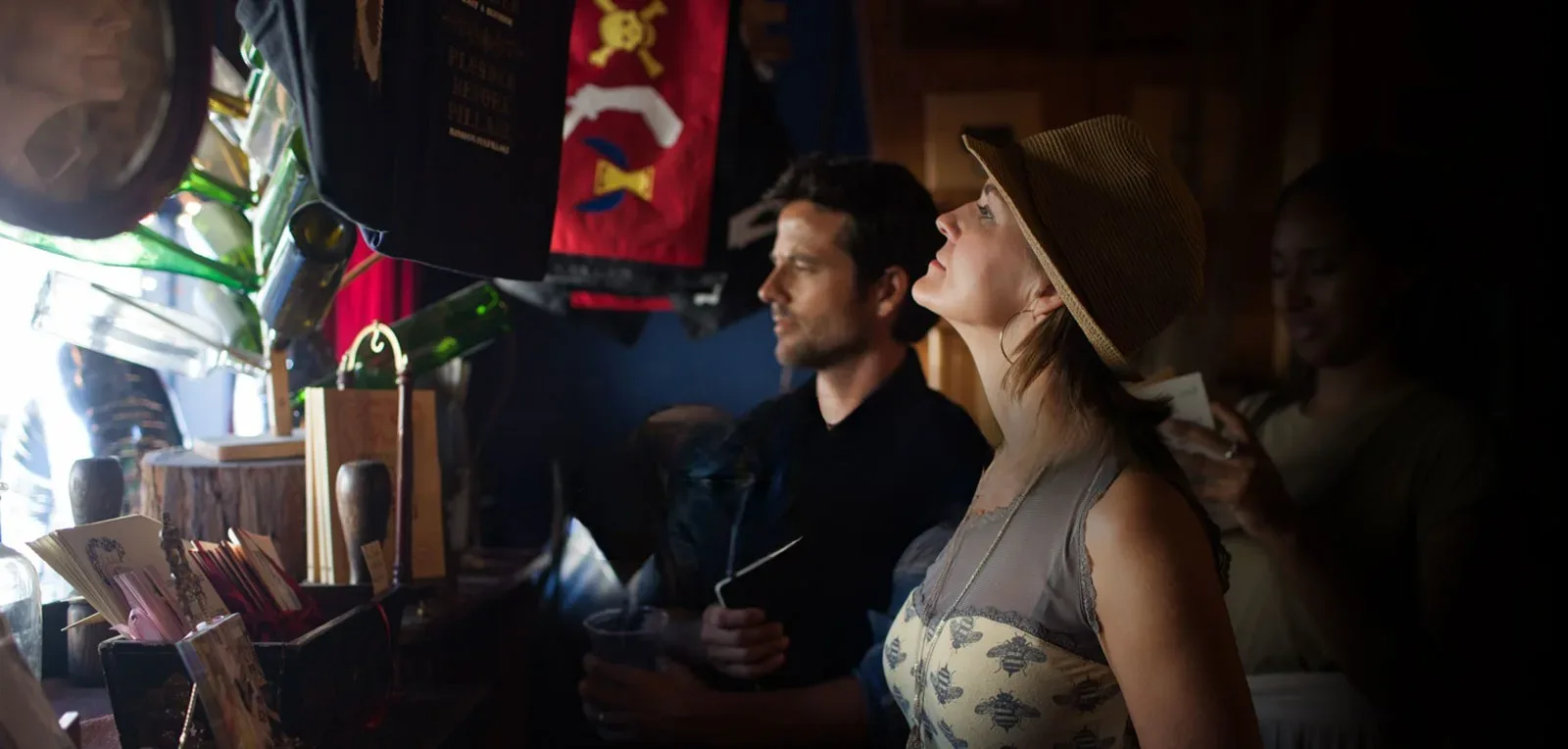 Shannon and Clay Cahoon browsing a curiosity shop together, pausing to look up at something that caught their attention.